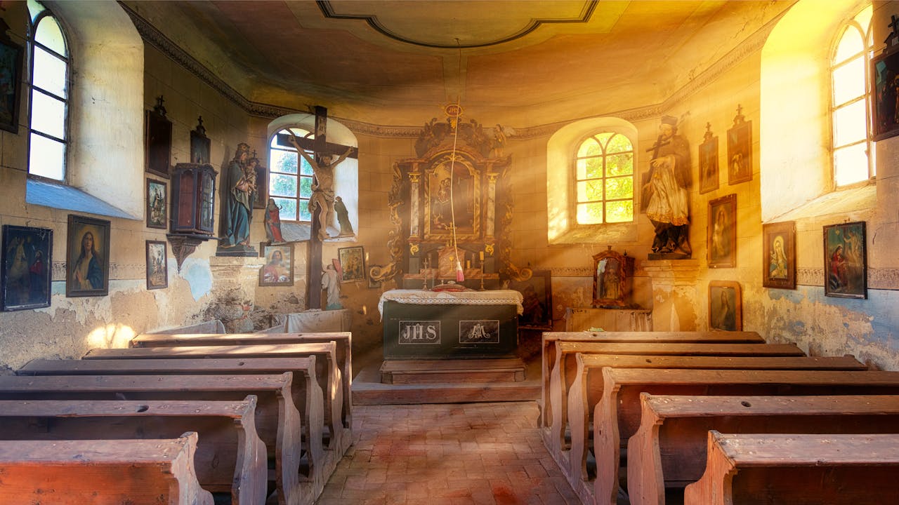 Beautiful rays of sunlight illuminating a historic church interior with classic architecture and religious art.